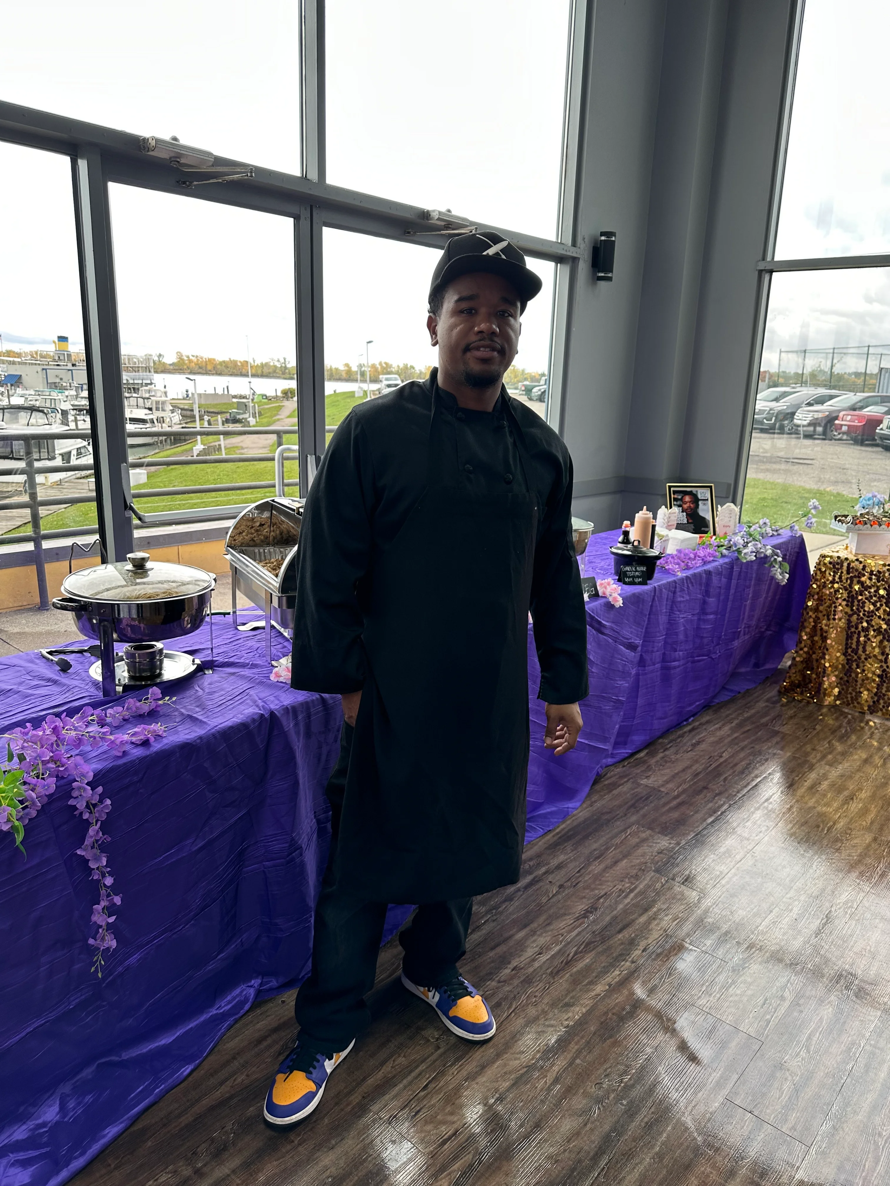 Chef in black apron at a vibrant event setup