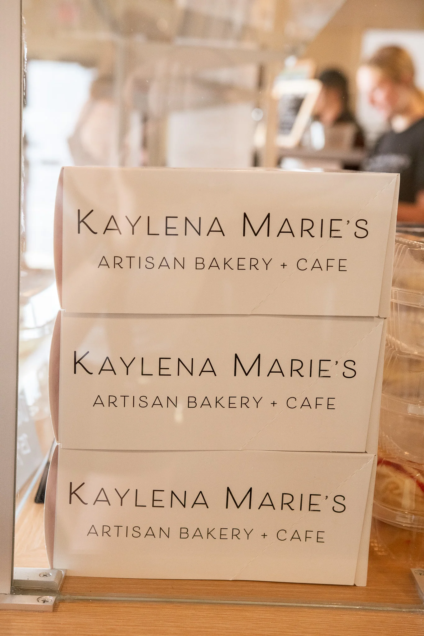 Artisan bakery boxes stacked in a cozy cafe