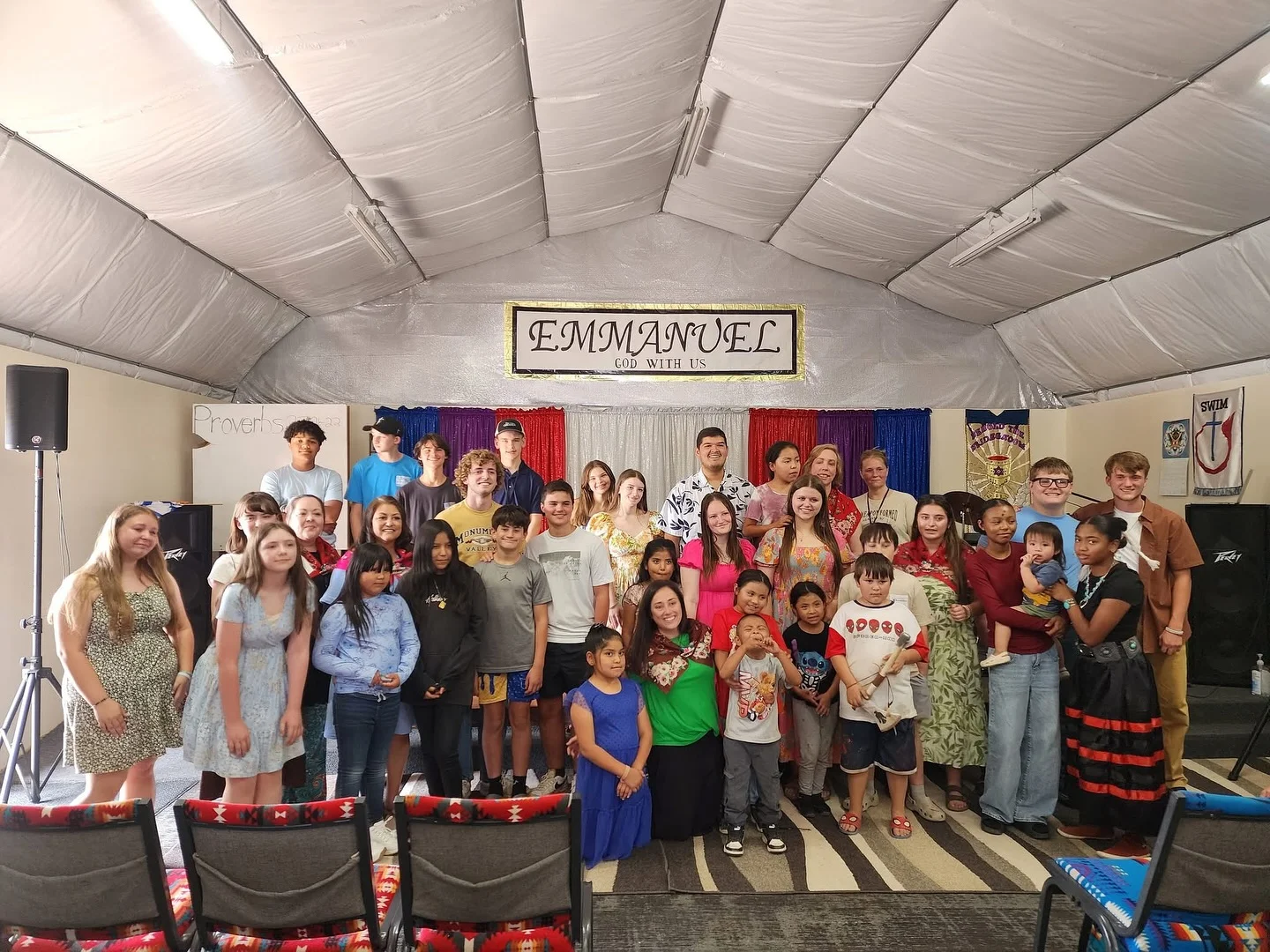 Group of children and teens at a community event in a decorated hall