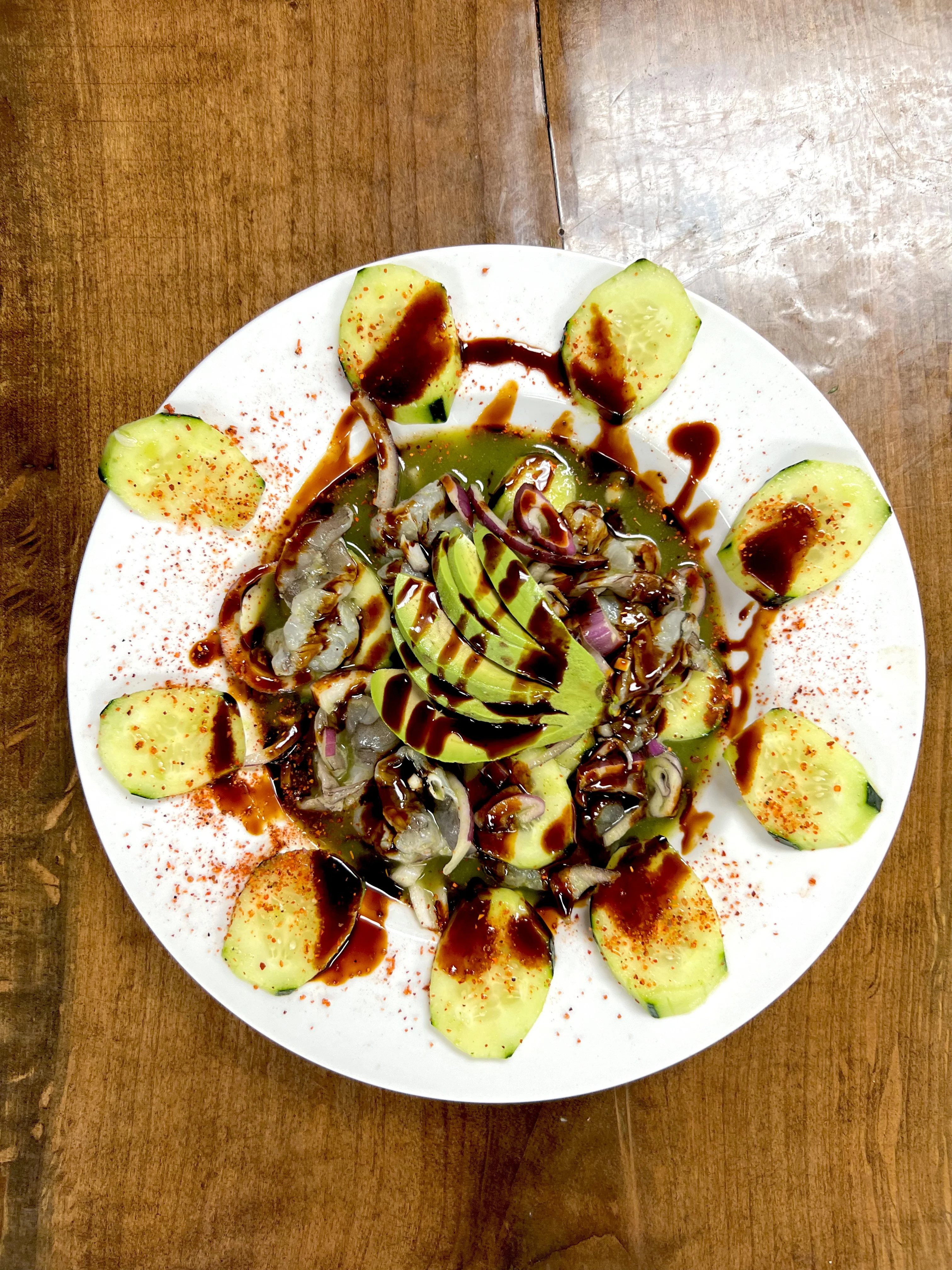 Mexican ceviche with avocado and cucumber slices