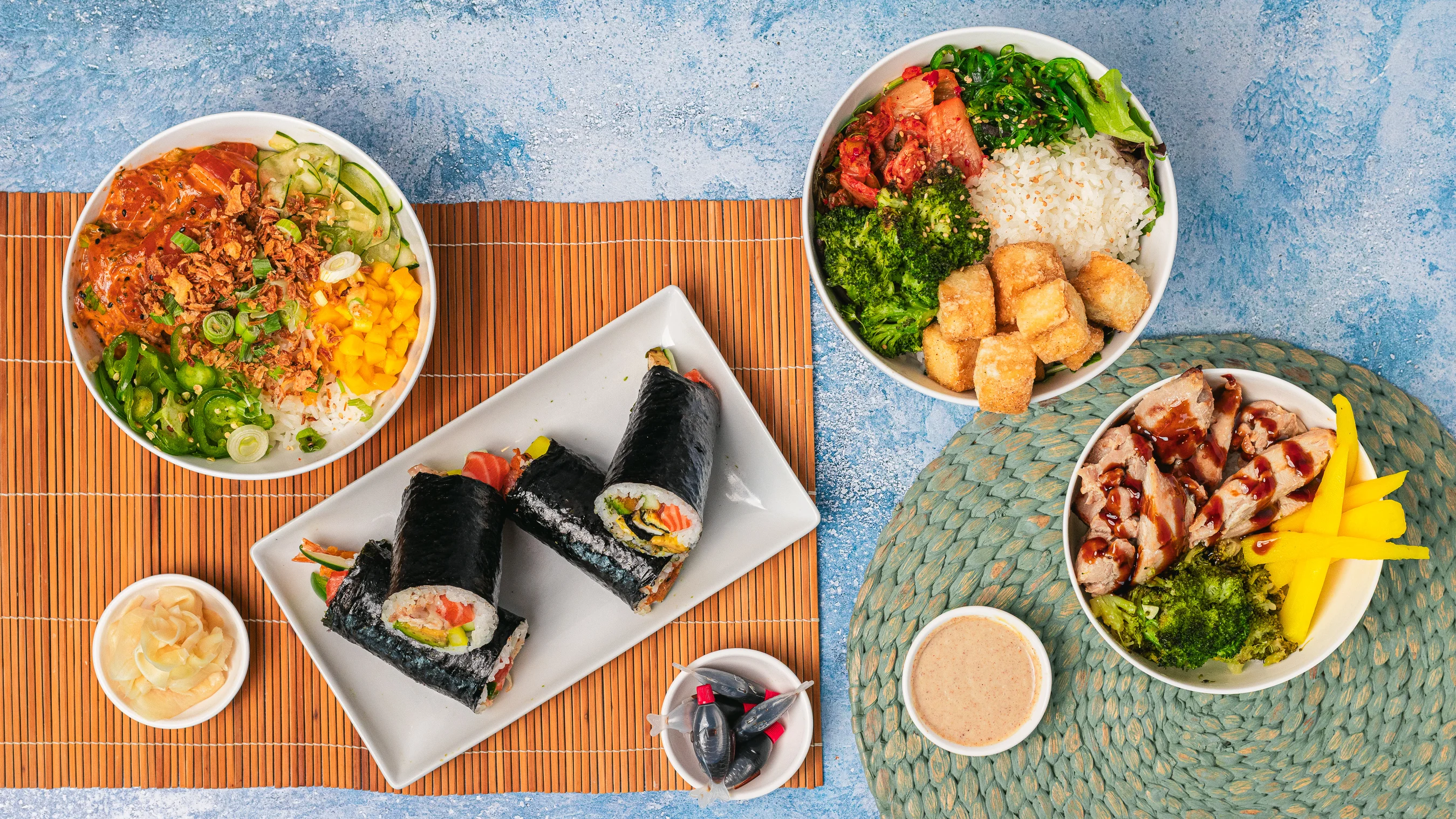 Variety of Asian dishes including sushi, rice bowls, and colorful drinks.