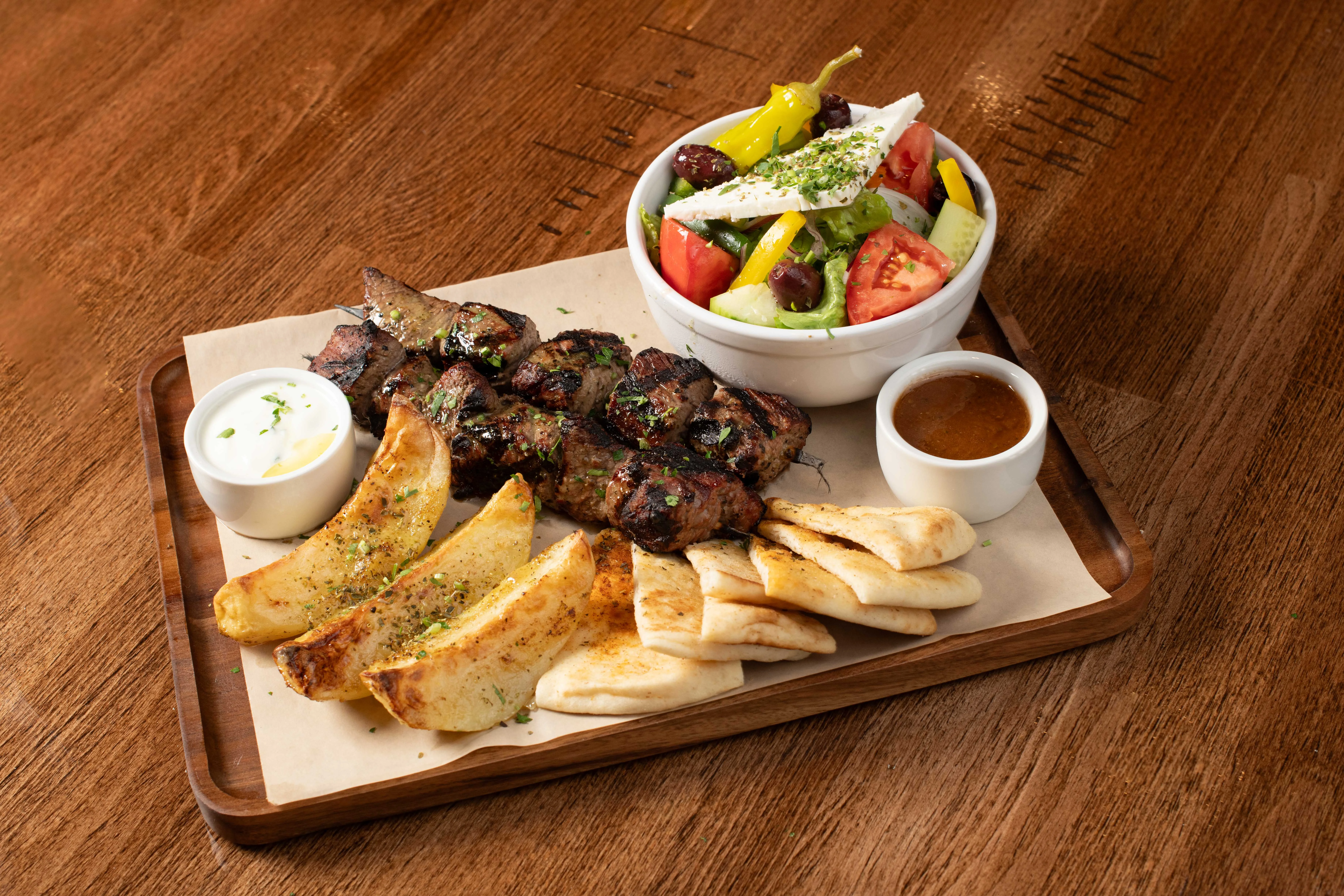 Grilled kebab platter with salad and pita bread