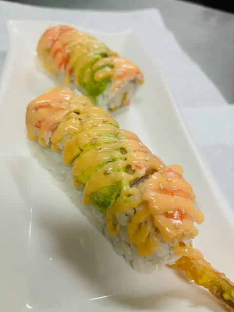 Colorful sushi rolls with spicy mayo drizzle