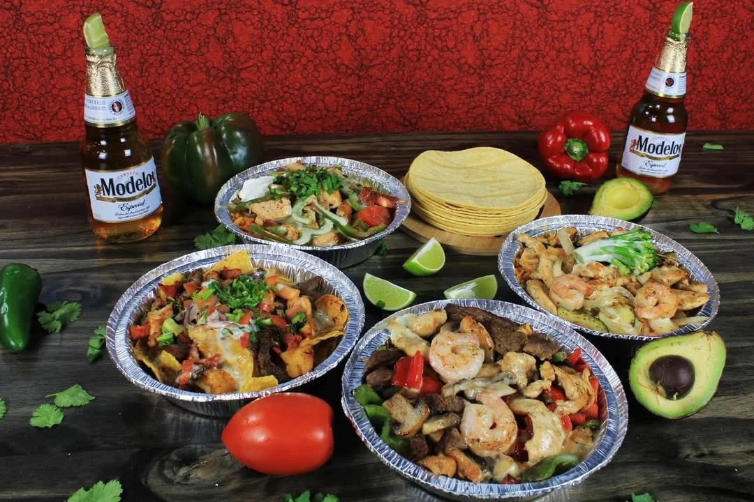 Colorful Mexican fajitas with tortillas and beer