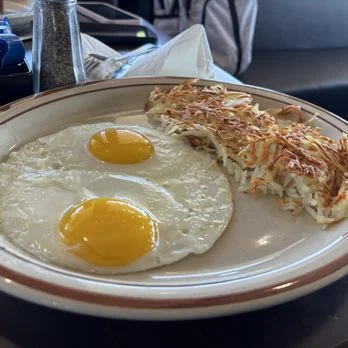 Classic American breakfast with sunny-side up eggs and hash browns