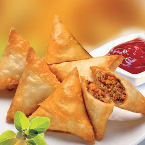 Crispy Indian samosas served with tangy ketchup