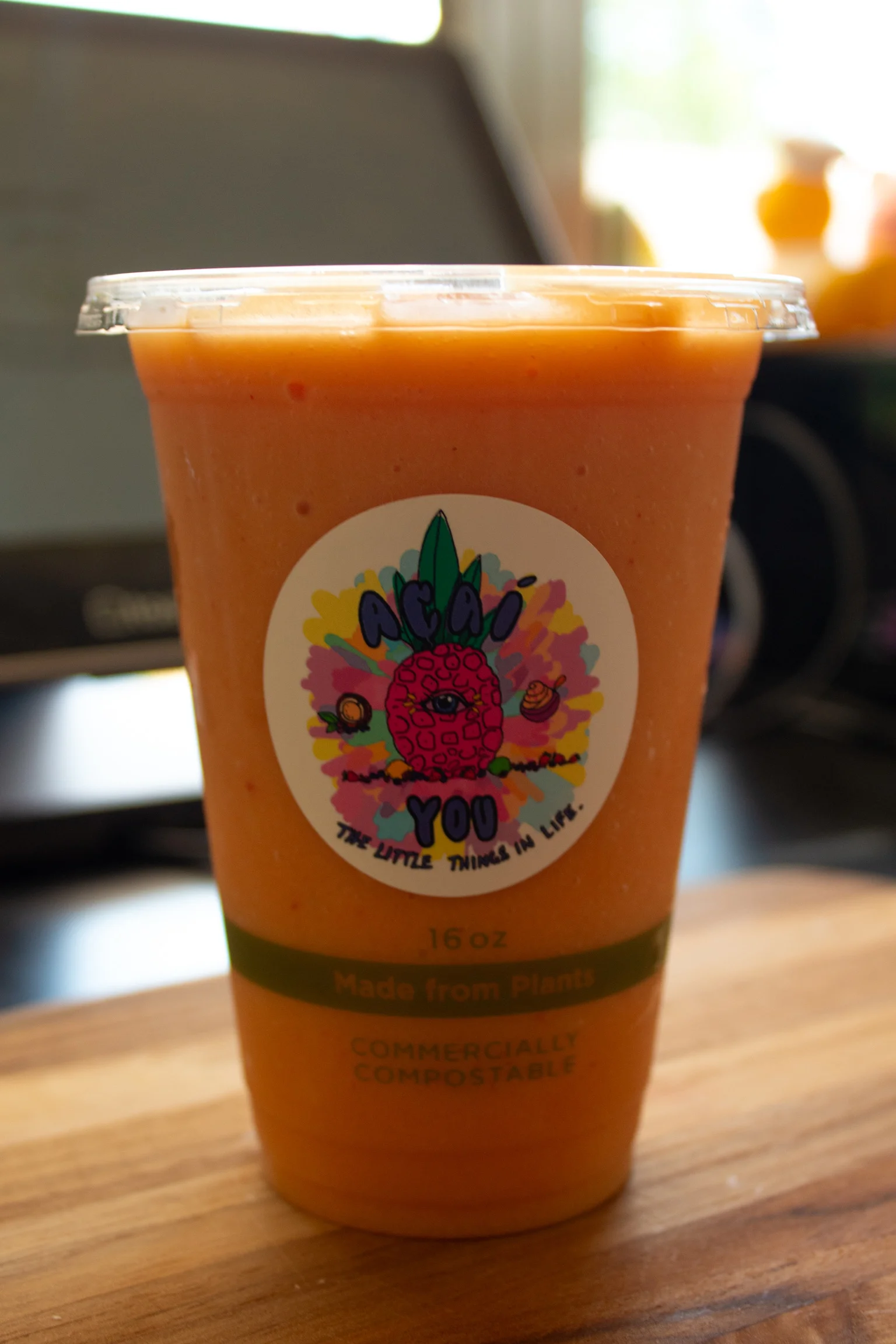 Refreshing acai smoothie in a compostable cup