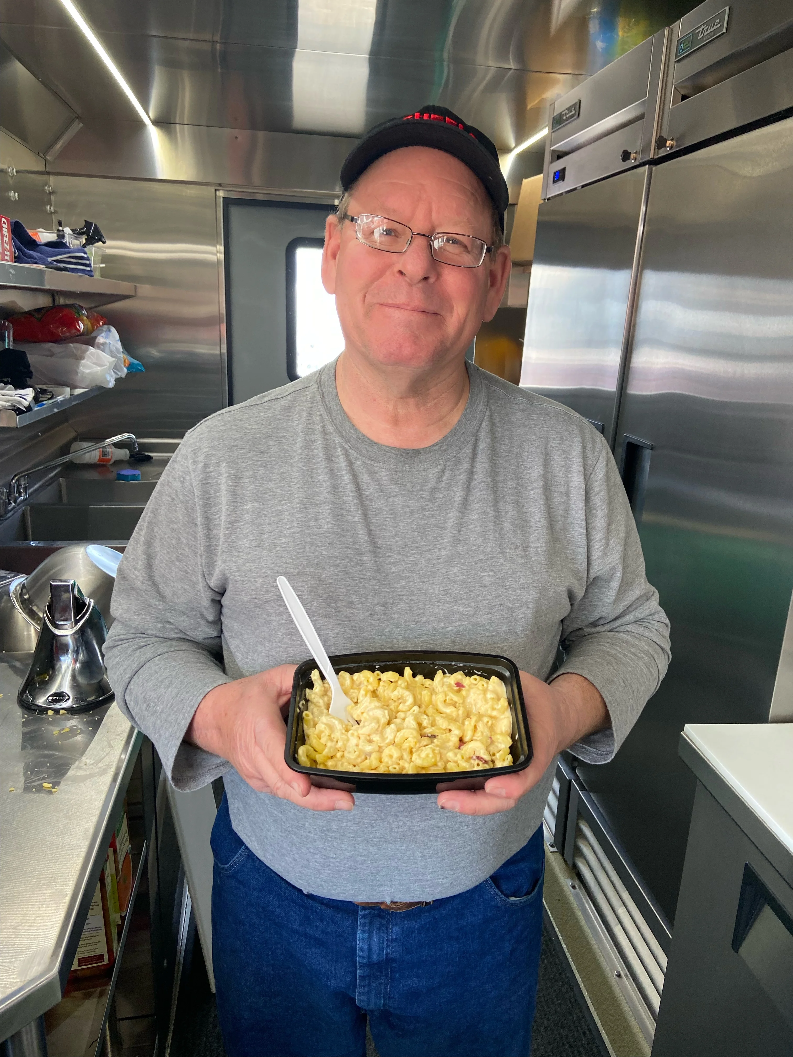 Creamy macaroni and cheese served in a takeout container