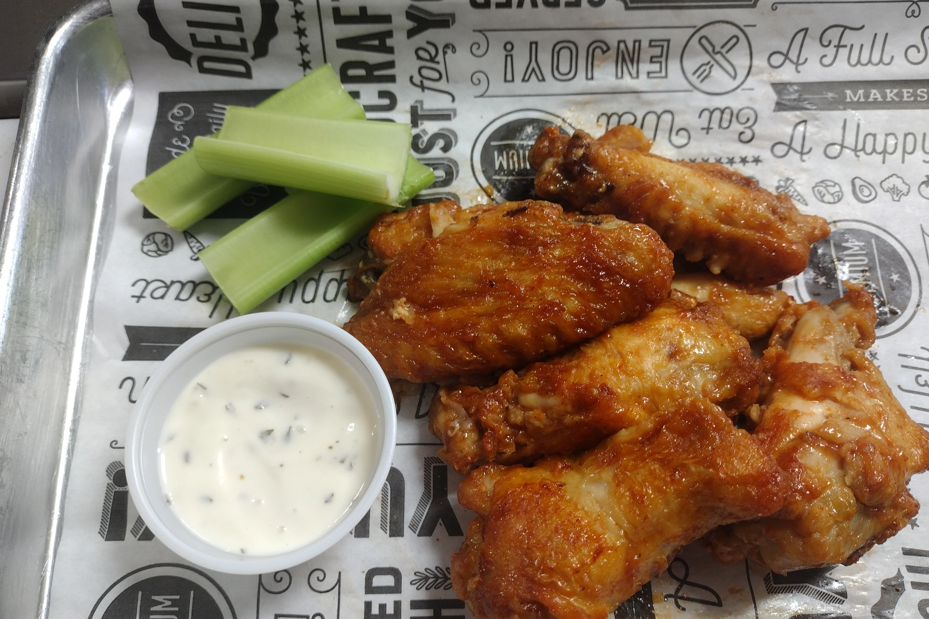 Crispy buffalo chicken wings with celery and ranch dressing