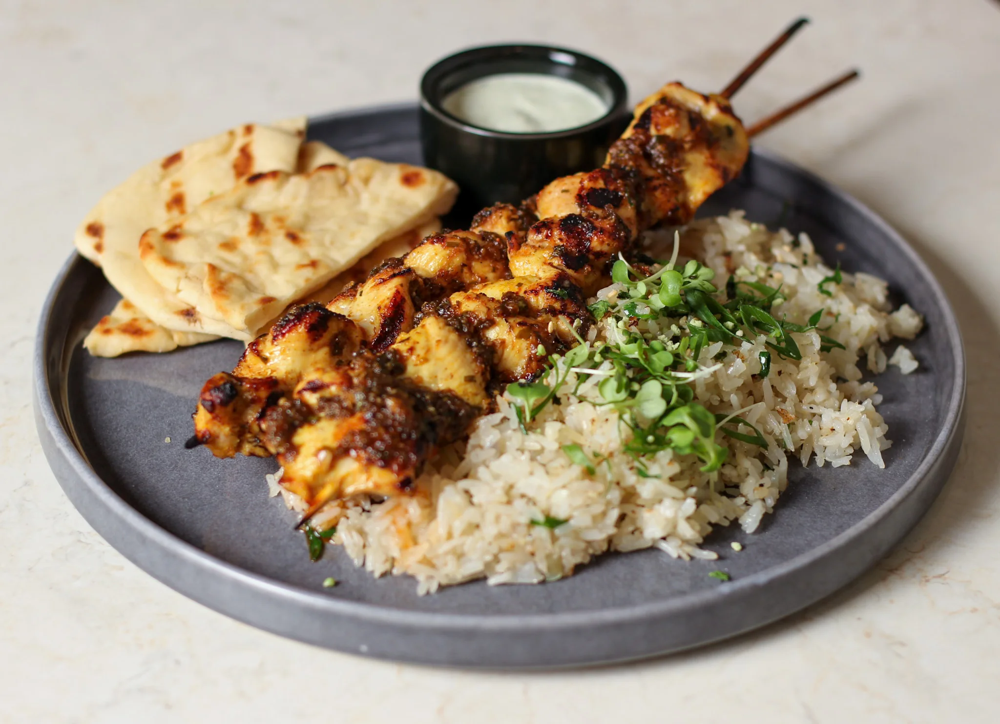 Grilled chicken kebabs with rice and naan