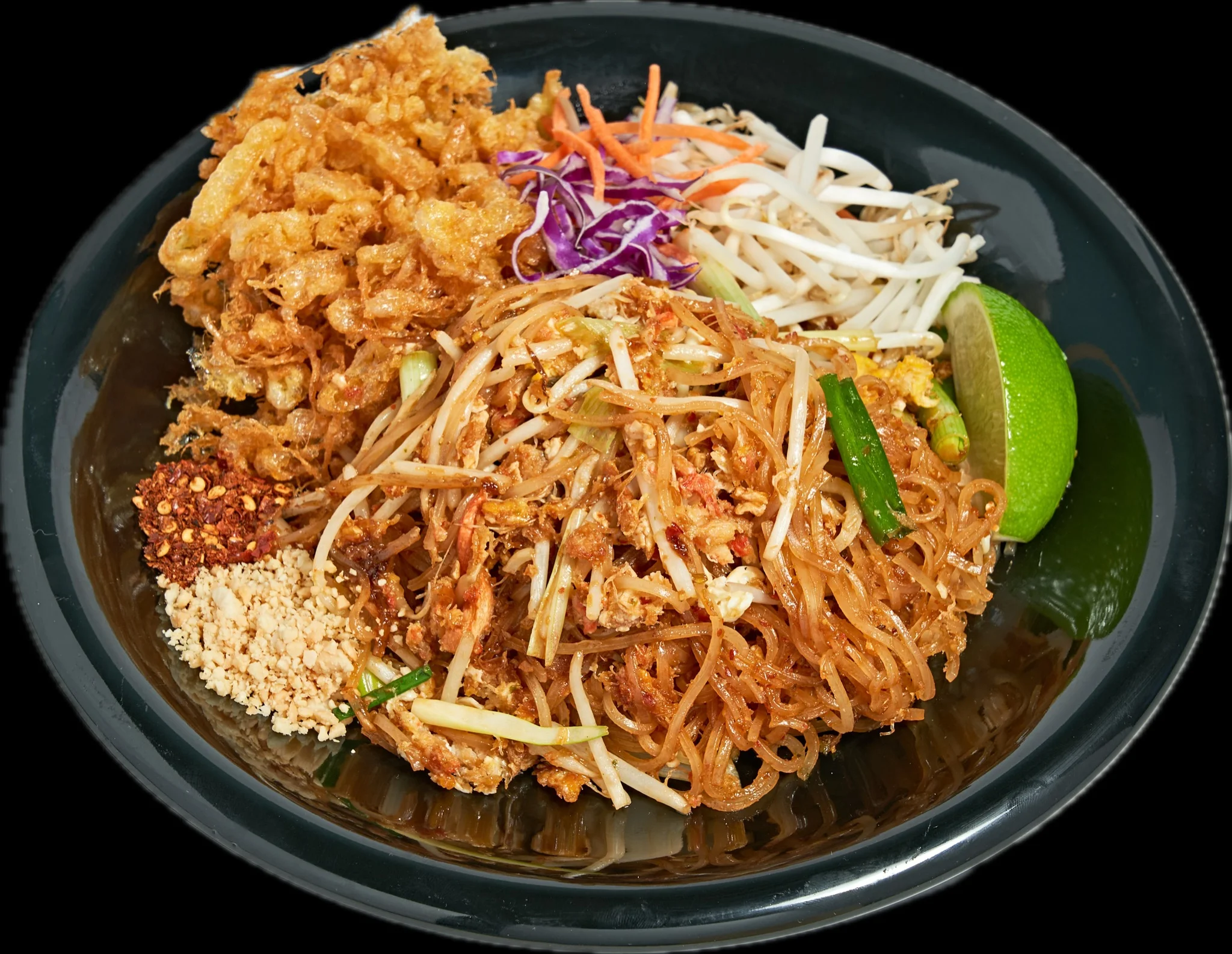 Plate of Thai pad thai with fresh lime and garnishes
