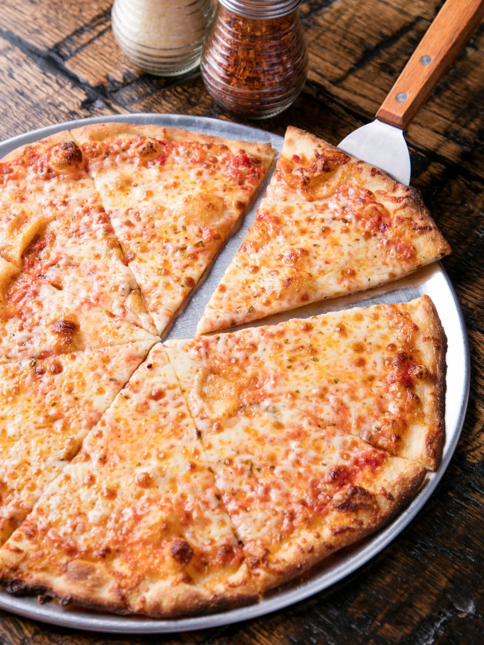 Classic cheese pizza on a metal tray