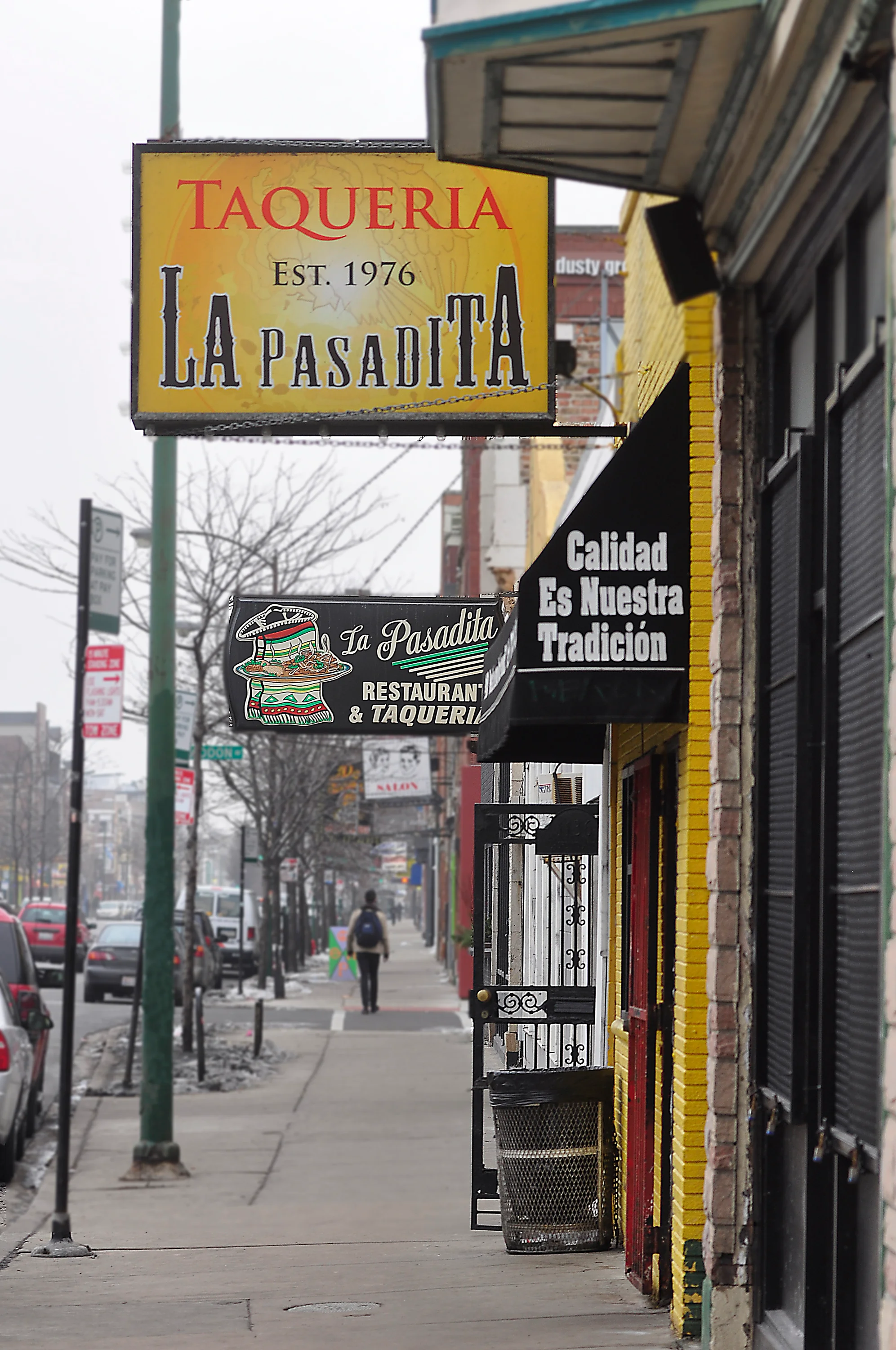 Colorful taqueria signage on a bustling street