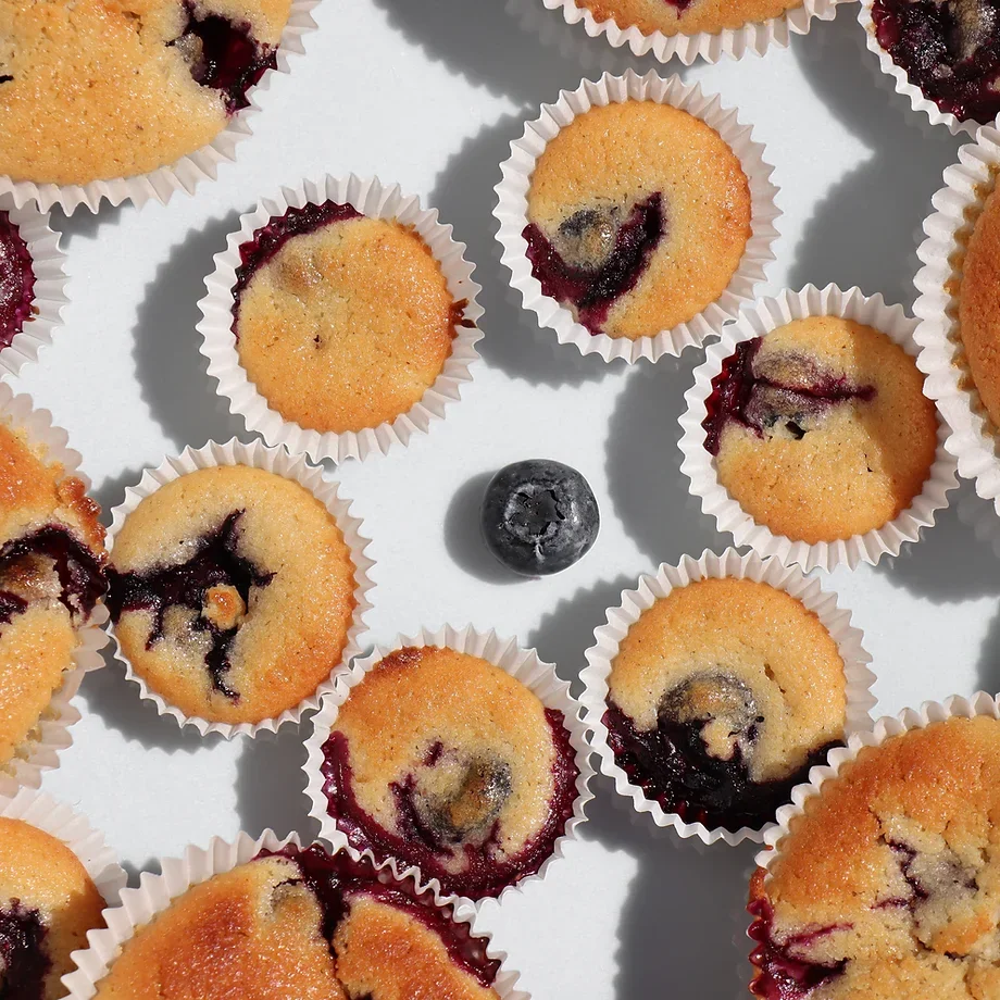 Freshly baked blueberry muffins on a white background