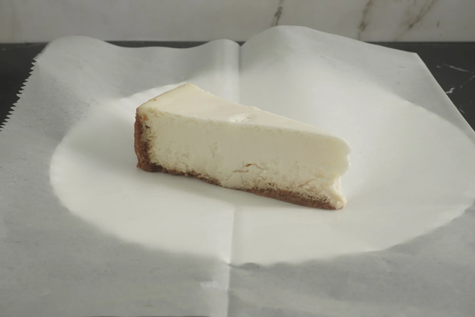 A Classic NY-style Cheesecake with a smooth, Creamy; texture and a Buttery graham cracker crust.