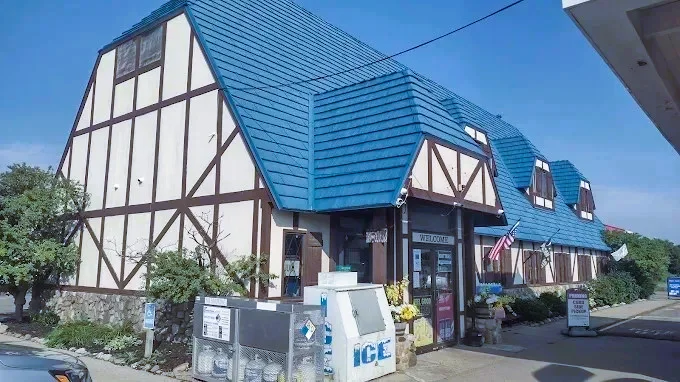 Charming restaurant exterior with blue roof and timber framing
