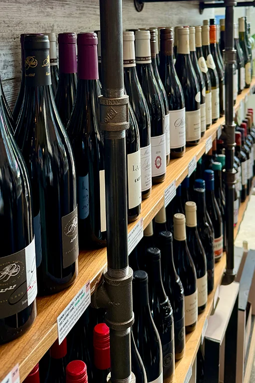 Wine shelf at La Boulangerie & Co Humboldt Park featuring 30 curated bottles on California Avenue