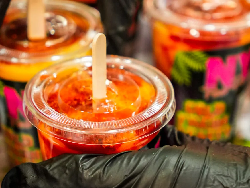 Colorful Mexican fruit cups with chili and lime
