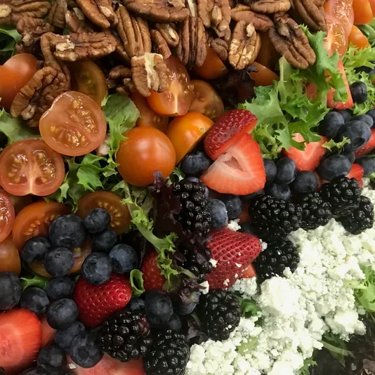 Colorful garden salad with mixed greens and berries