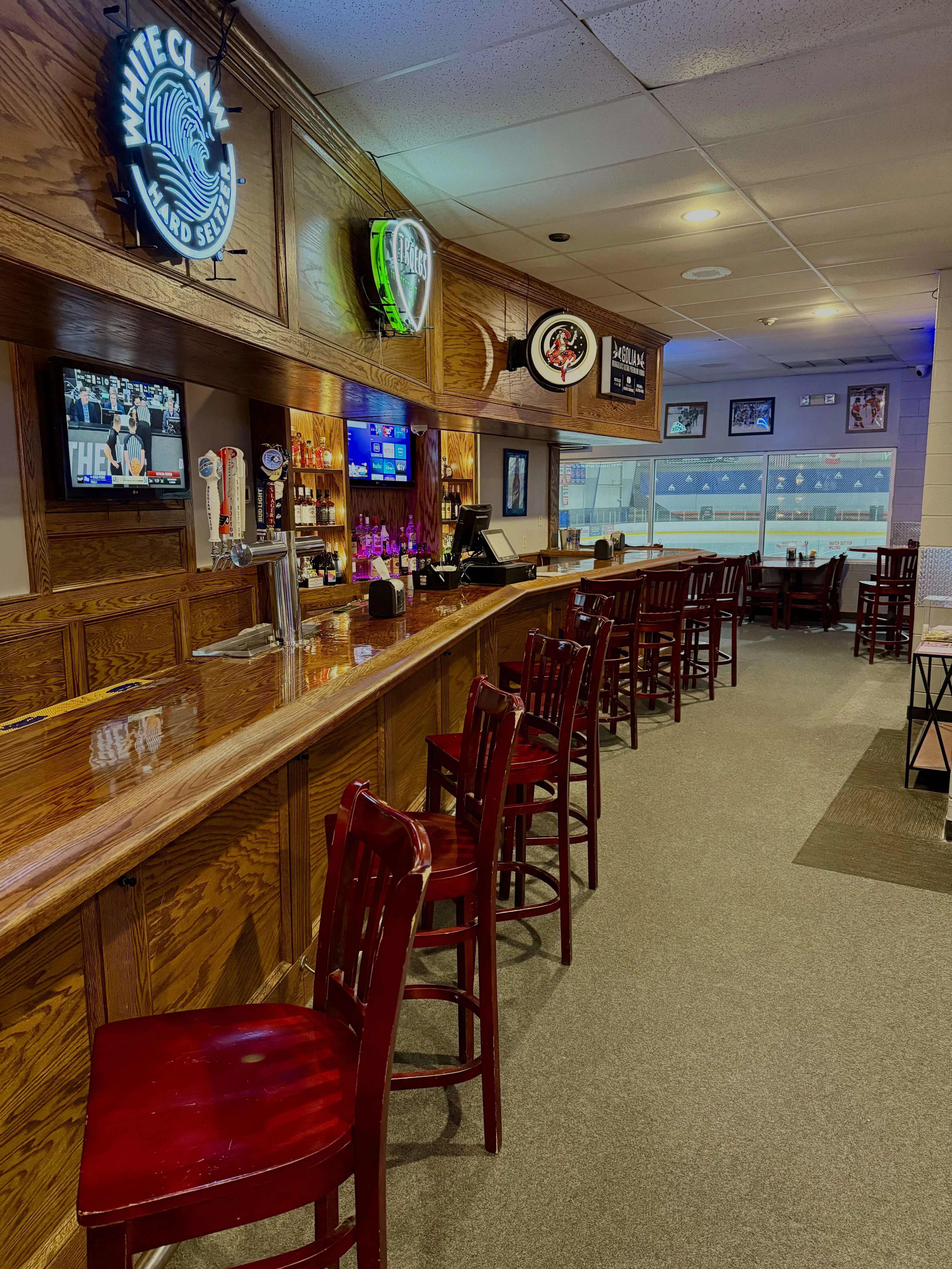 Cozy bar interior with wooden counter and neon signs