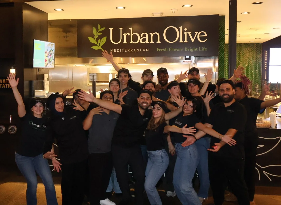 Culinary team showcasing Mediterranean dishes at a restaurant