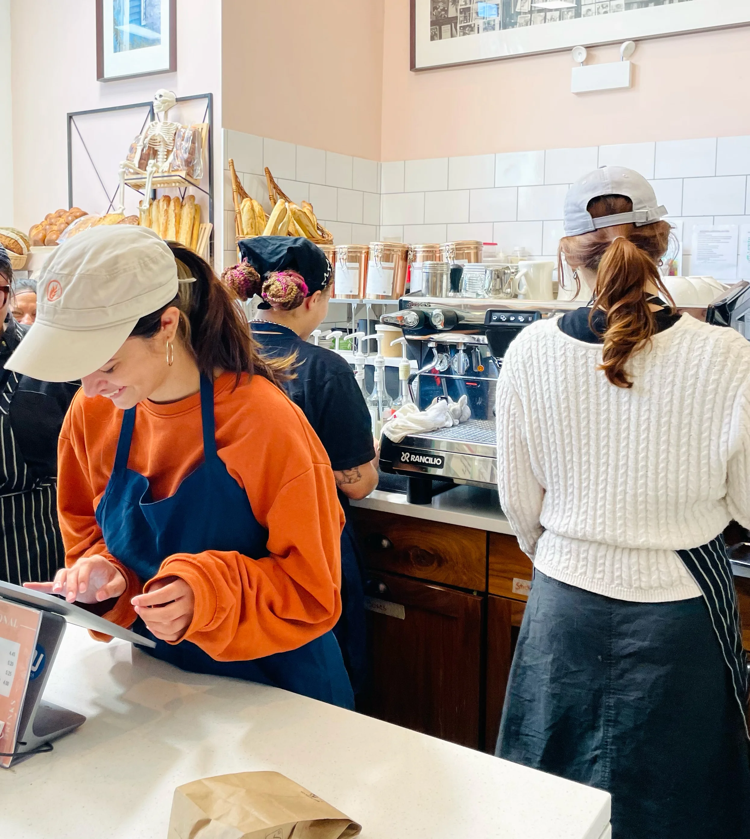 Barista preparing coffee in a cozy café interior