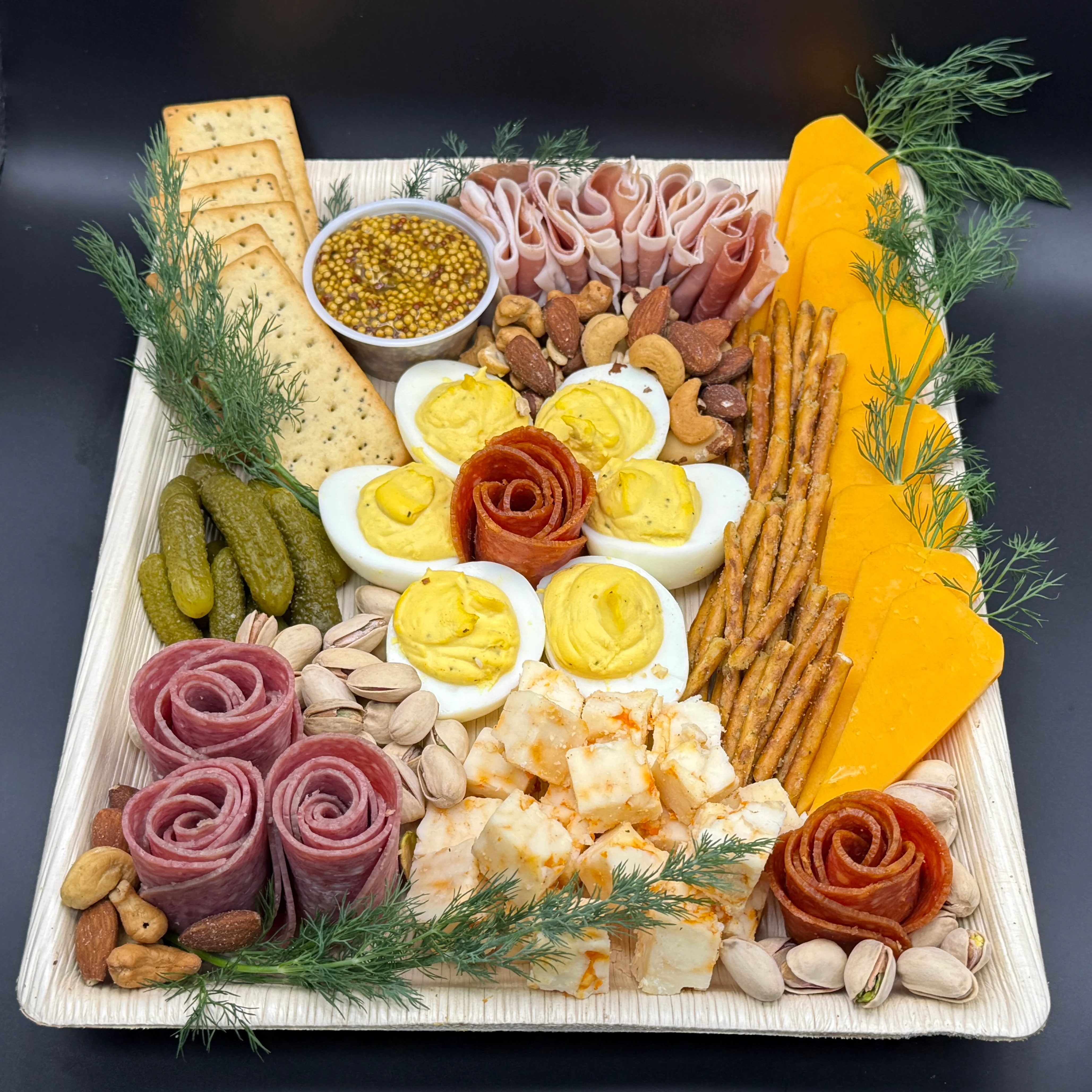 Charcuterie board with assorted meats, cheeses, and garnishes