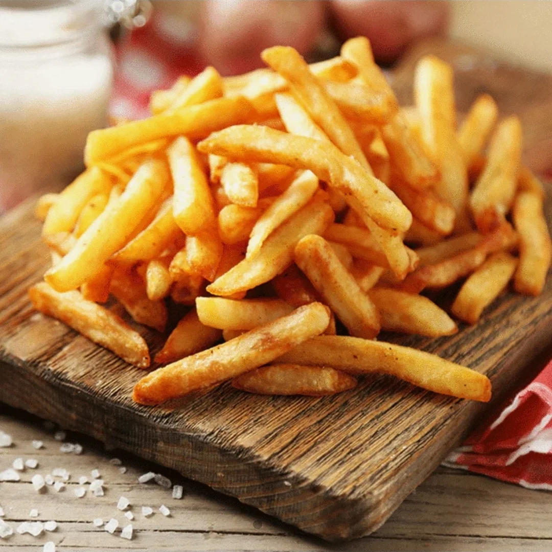 Crispy French fries served on a wooden platter