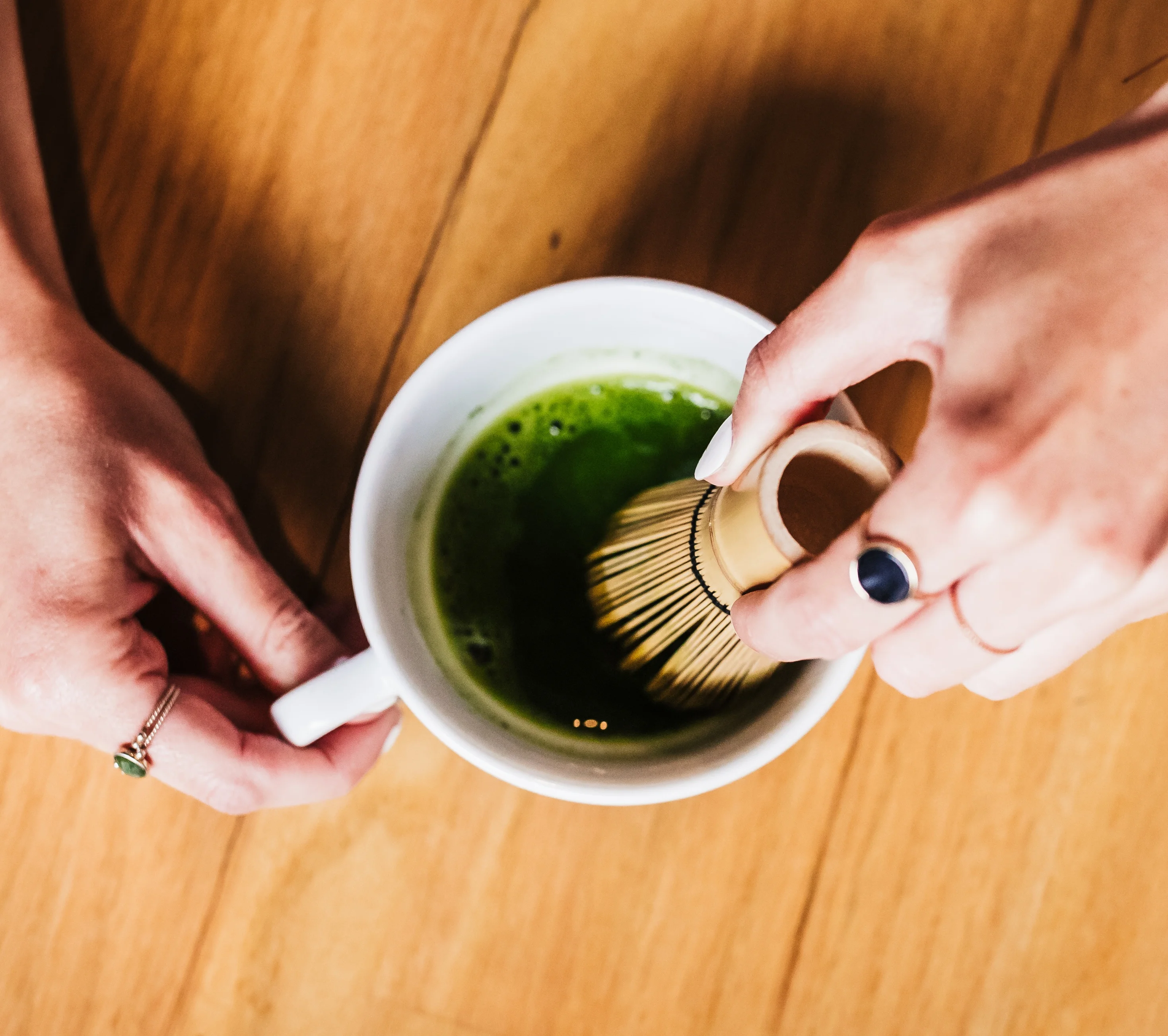Whisking matcha tea in a traditional bowl