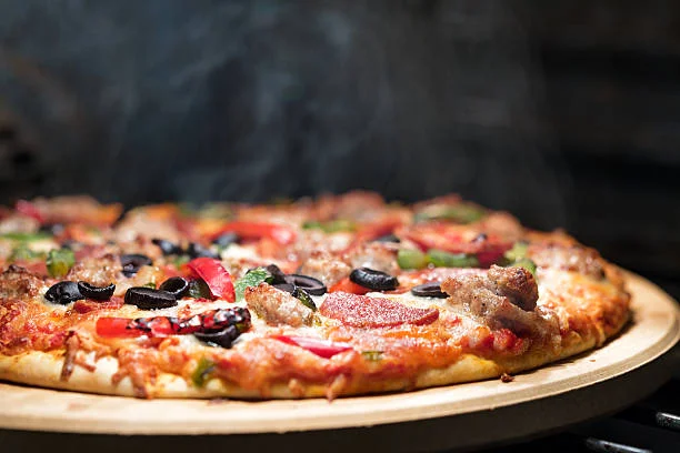 Delicious pizza with various toppings on a wooden table.