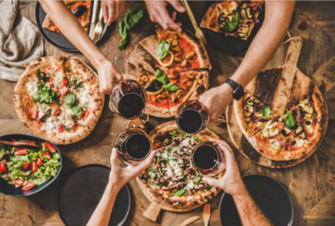 Gathering with red wine and wood-fired pizzas