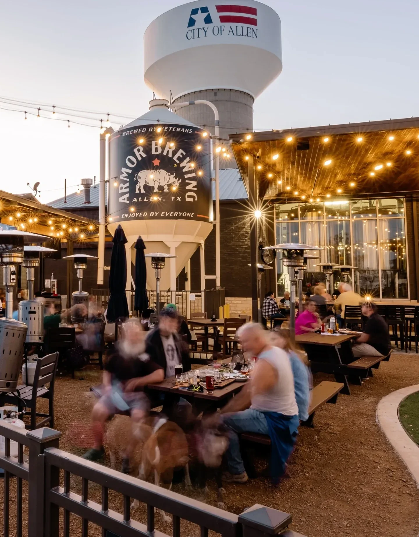 Outdoor brewery patio with string lights and lively atmosphere