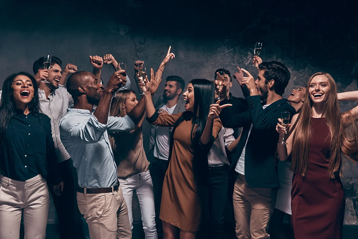 Group of friends celebrating with drinks at a party