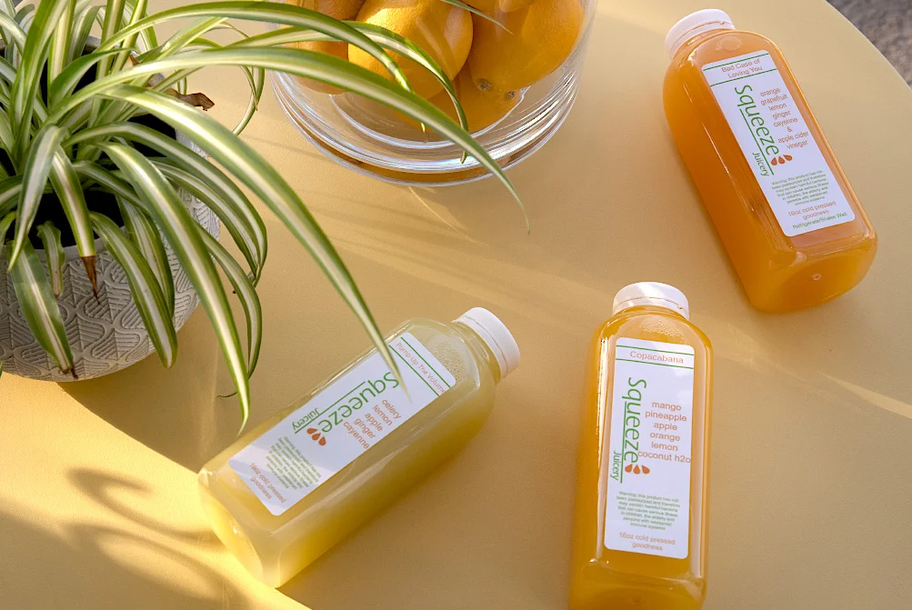 Refreshing cold-pressed juices on a sunny table