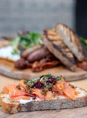 Open-faced smoked salmon toast on rustic bread
