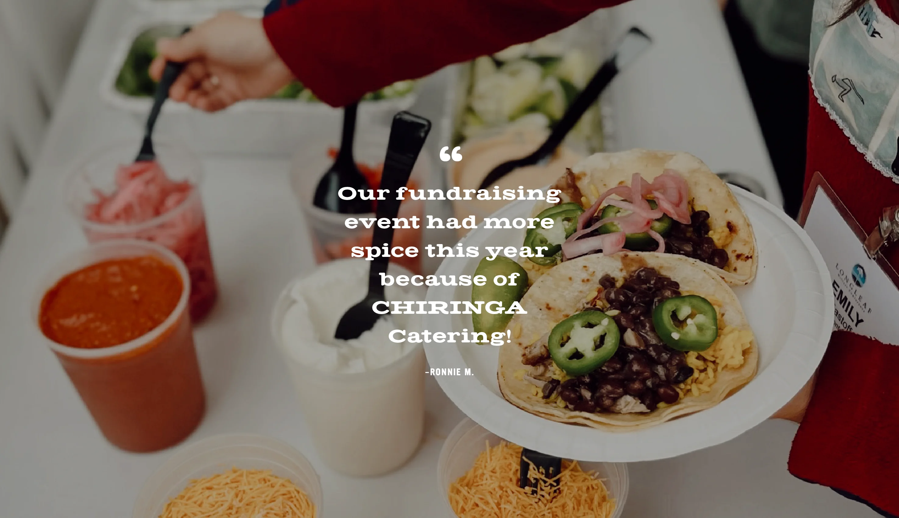 A photo of a woman dishing up her taco meal from CHIRINGA's catering spread. Our office parties have never been better! The variety in the meal boxes keeps everyone happy—even our pickiest eaters  are pleased.