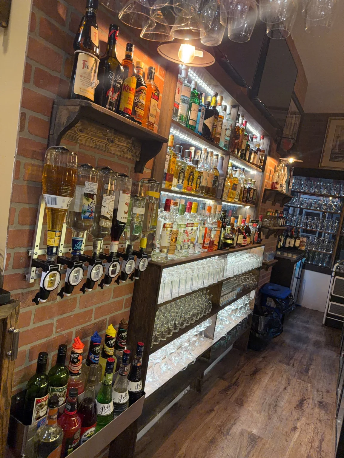 Villa Italiana bar with illuminated bottles and glassware