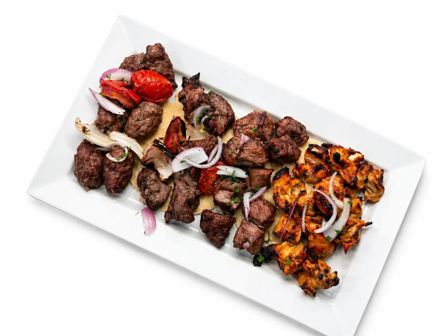 Mixed grill platter featuring kebabs and grilled vegetables