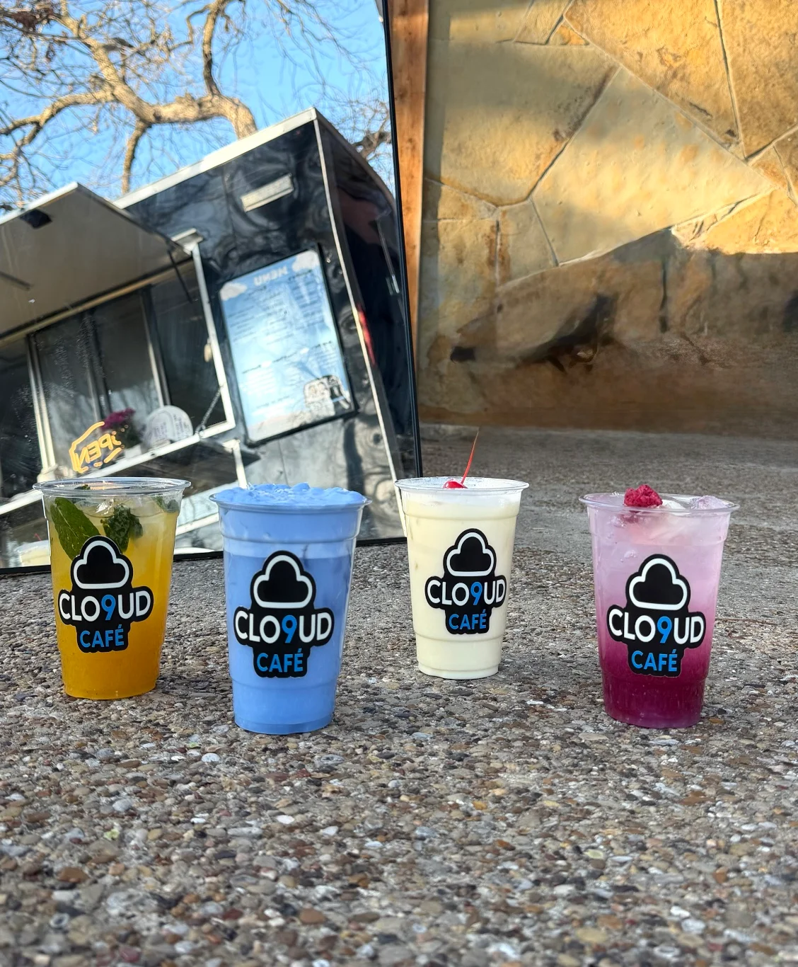 Colorful drinks at Clo9ud Café in a vibrant outdoor setting