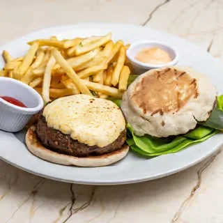 Gourmet burger with fries and dipping sauces