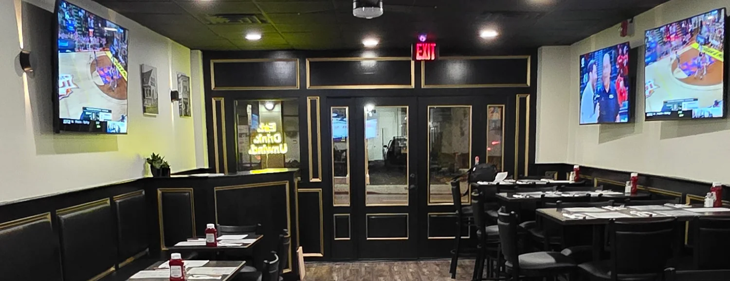 Modern restaurant interior with seating and TVs