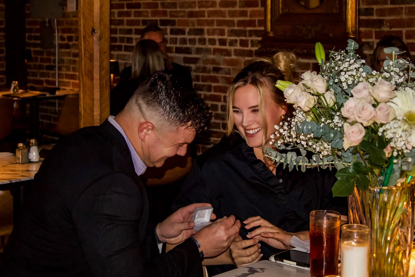 Couple celebrating a special moment in a cozy restaurant setting