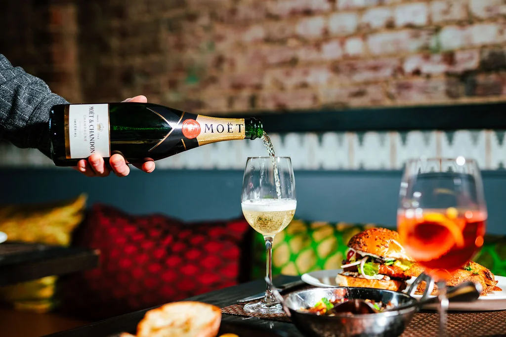 Pouring Moët champagne in a stylish restaurant setting
