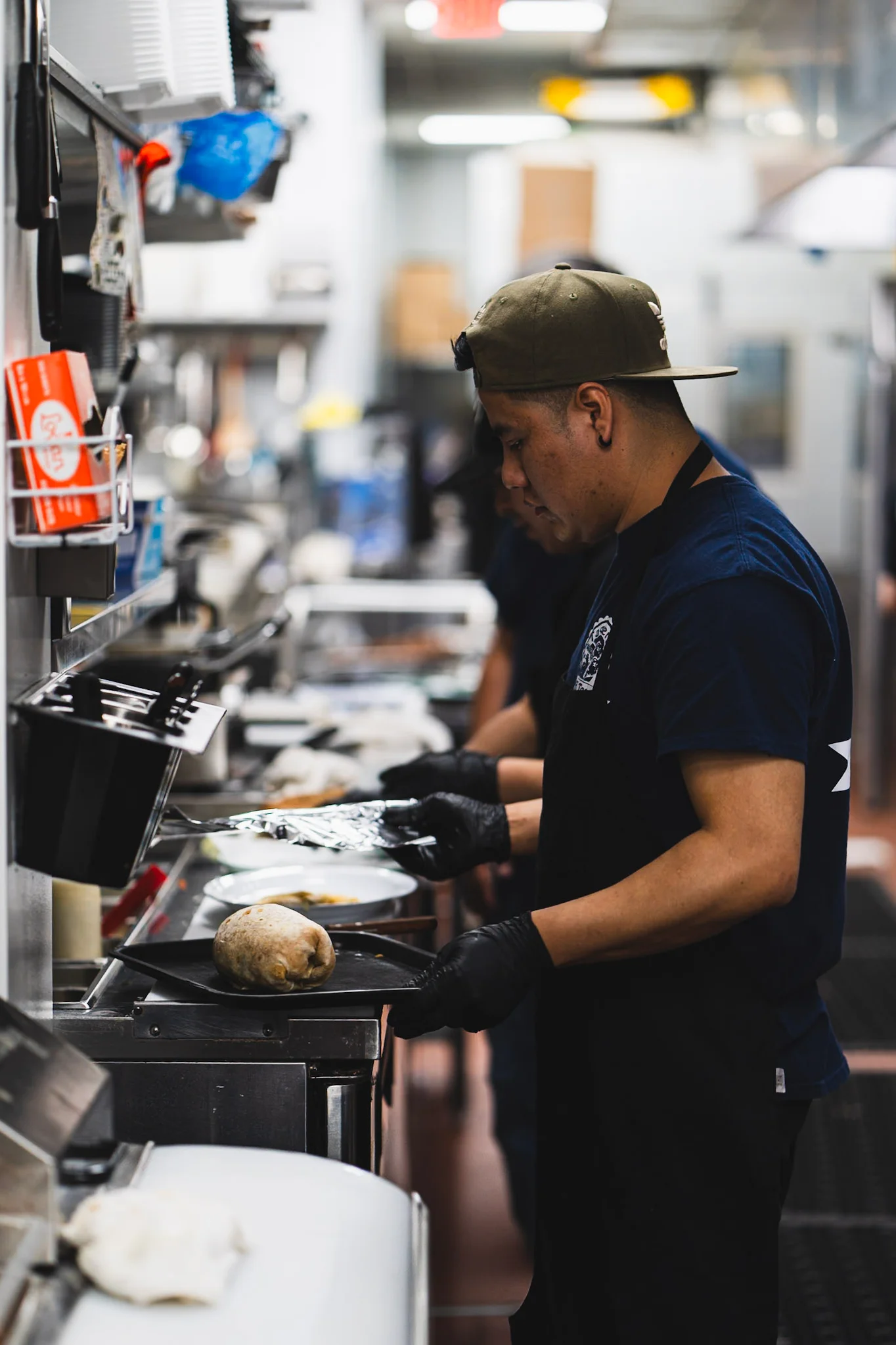 Chefs preparing dishes in a busy restaurant kitchen