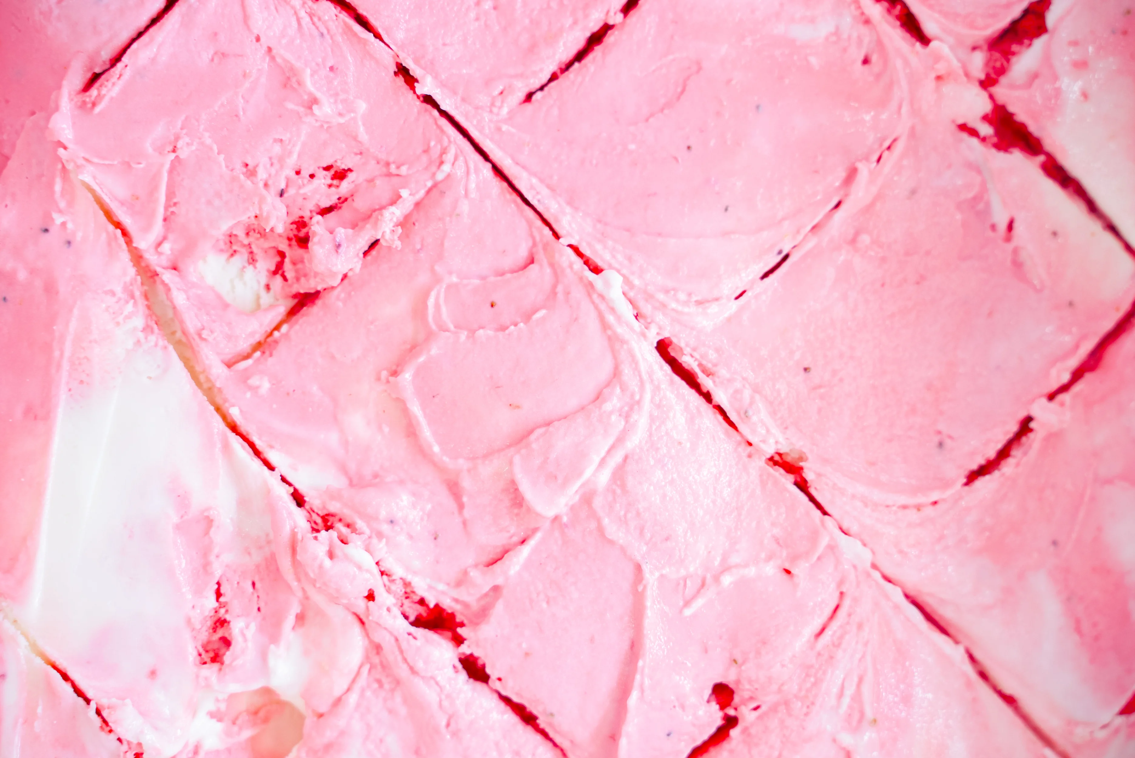Creamy strawberry gelato in a textured scoop
