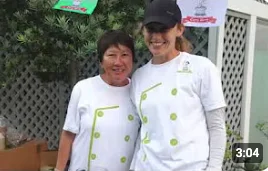 Two chefs smiling at a culinary event