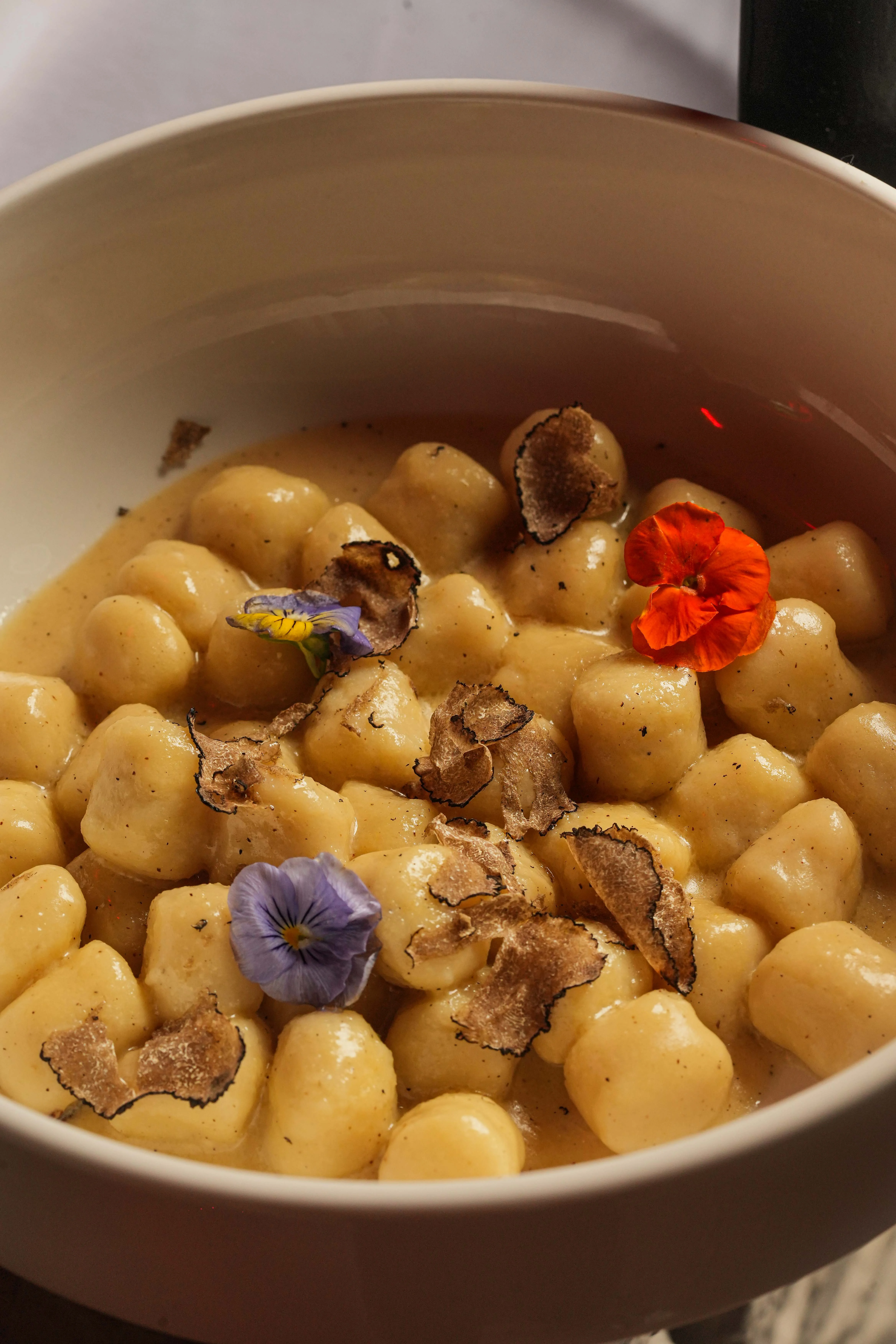 Creamy Italian gnocchi with truffle and edible flowers