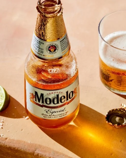 Chilled bottle of Modelo beer with lime and glass