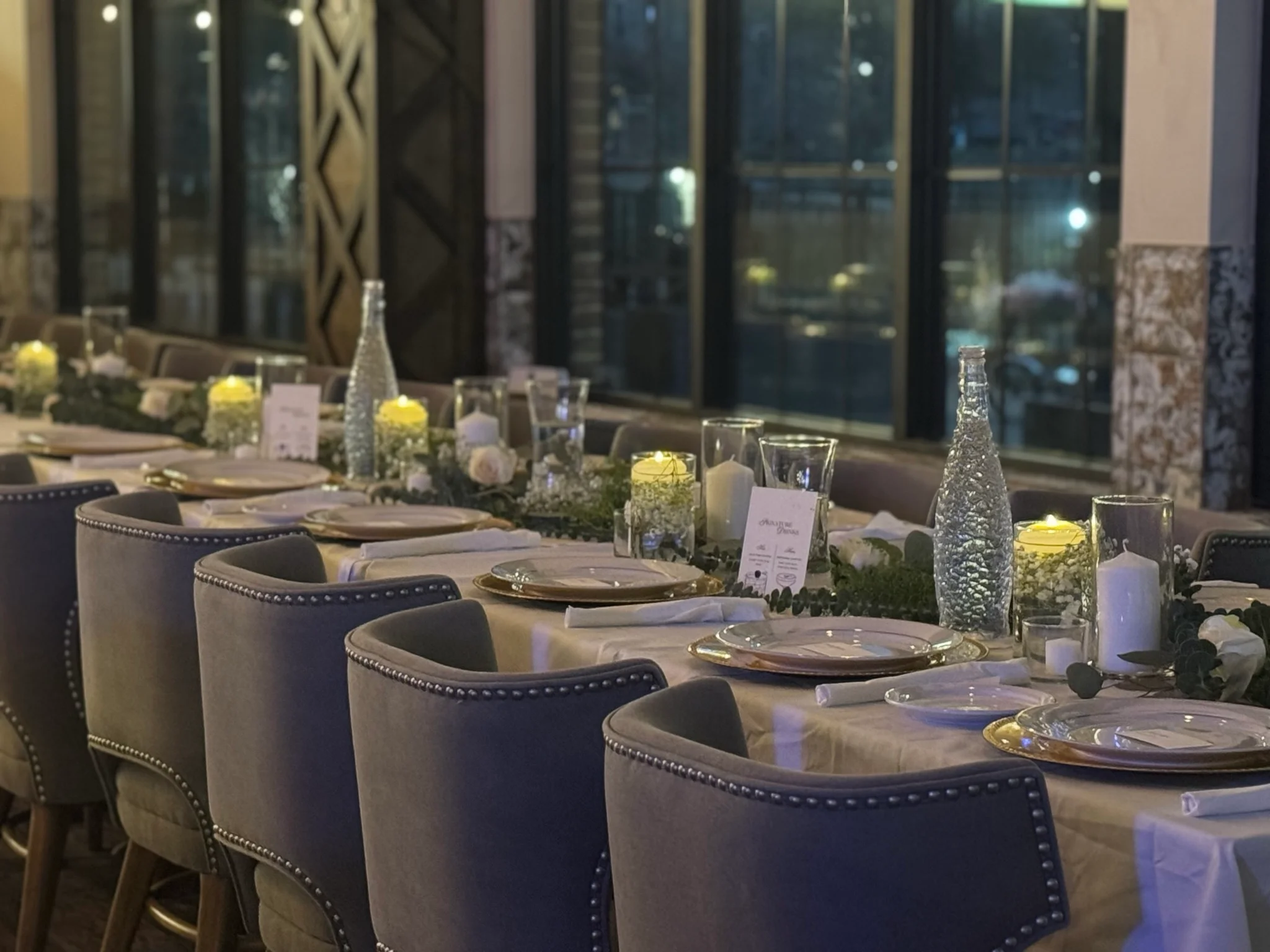 Elegant restaurant dining setup with candles and floral decor