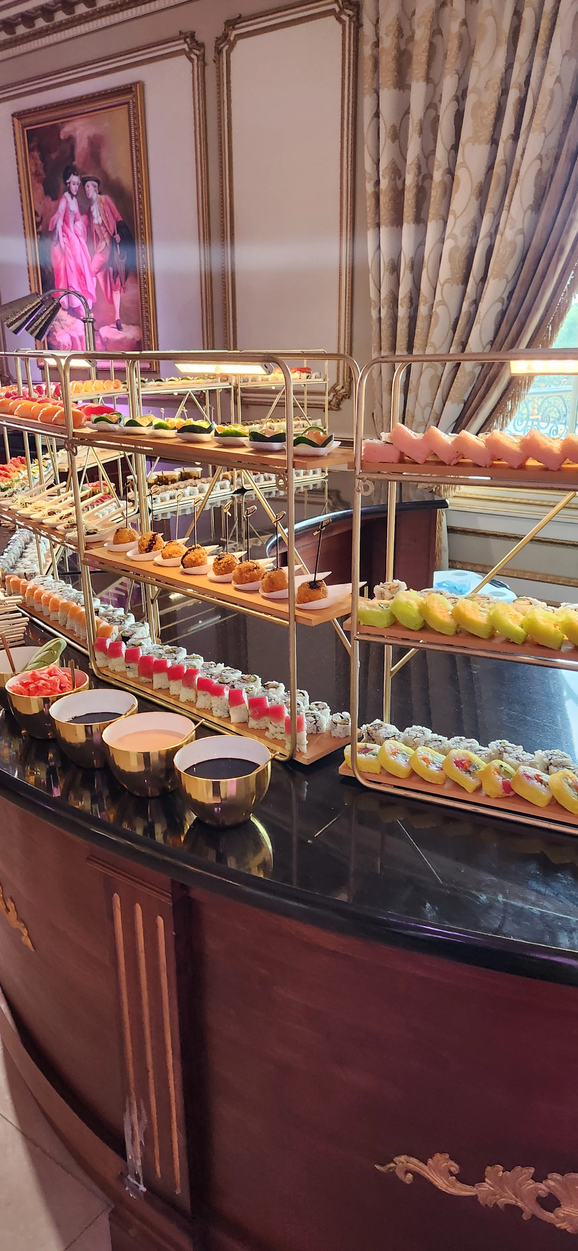 Elegant dessert display featuring assorted sushi and sweets in a luxurious setting